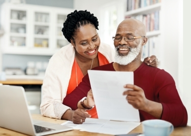 Couple looking at documents on table.