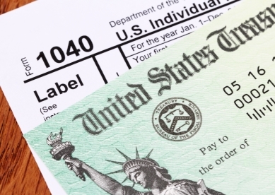 Tax Refund Check on Top of 1040 Form