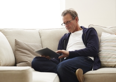 Man looking at iPad on Couch
