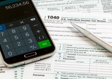 Phone Calculator Sitting on Tax Documents